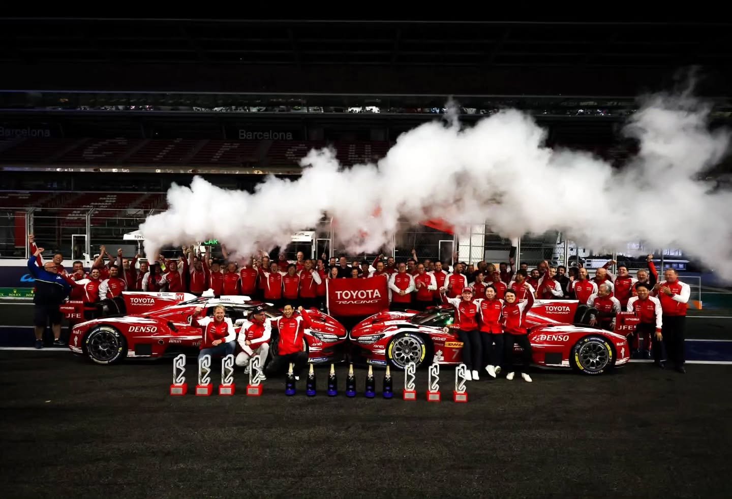 Toyota Racing team celebrating the 2026 World Manufacturers' Championship with both TR010 HYBRID cars